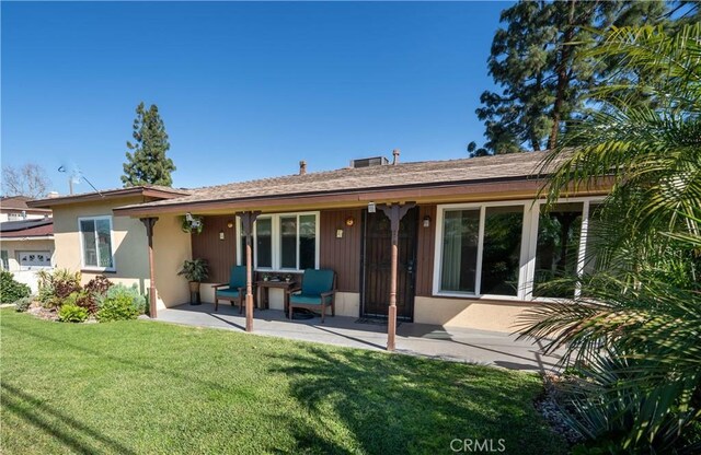 12821 Salisbury St, Baldwin Park, CA 91706 - rear view of house featuring a lawn and stucco siding