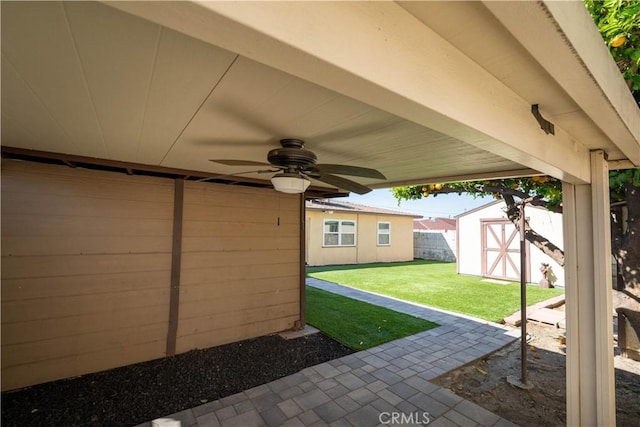 12821 Salisbury St, Baldwin Park, CA 91706 - view of patio featuring a ceiling fan, fence, an outdoor structure, and a storage unit