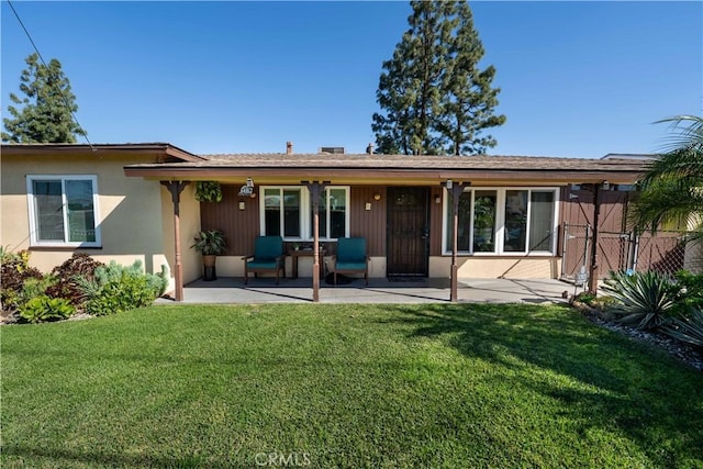 12821 Salisbury St, Baldwin Park, CA 91706 - rear view of property featuring a yard, a patio area, stucco siding, and fence