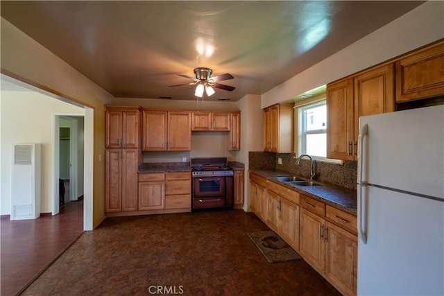 12821 Salisbury St, Baldwin Park, CA 91706 - kitchen featuring ceiling fan, freestanding refrigerator, a sink, range with gas stovetop, and decorative backsplash