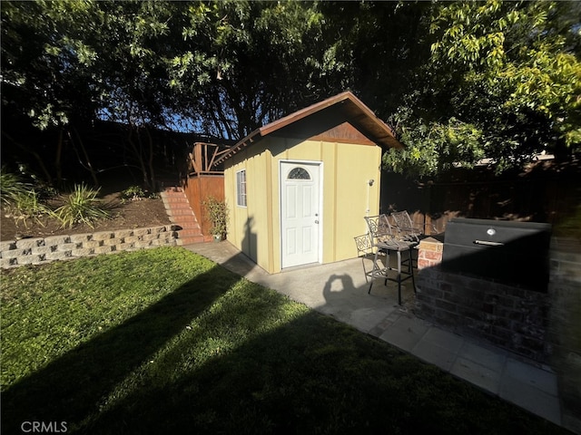 view of shed featuring fence and stairs