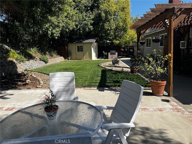 view of patio featuring a pergola, fence, an outbuilding, and outdoor dining space