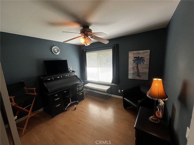 office featuring a ceiling fan, baseboards, and wood finished floors