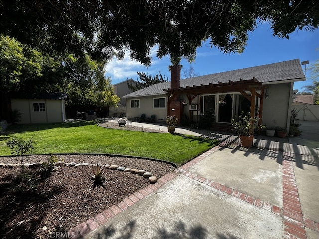 back of property with a lawn, an outbuilding, a patio area, fence, and a pergola