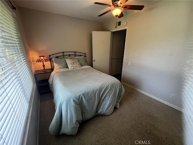 carpeted bedroom featuring a ceiling fan, baseboards, and visible vents