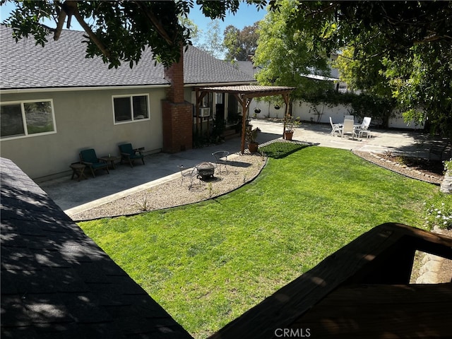 rear view of house featuring a fire pit, a pergola, a patio, roof with shingles, and stucco siding