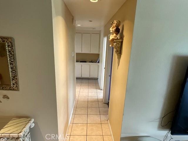 hall featuring light tile patterned flooring and recessed lighting