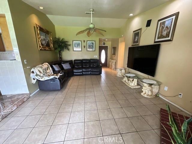 living area featuring vaulted ceiling, a ceiling fan, light tile patterned floors, baseboards, and visible vents