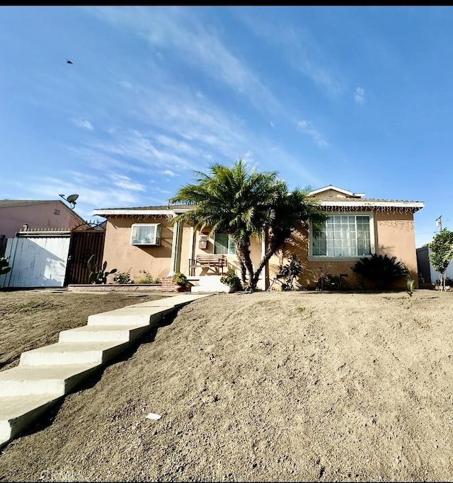 ranch-style house featuring stucco siding