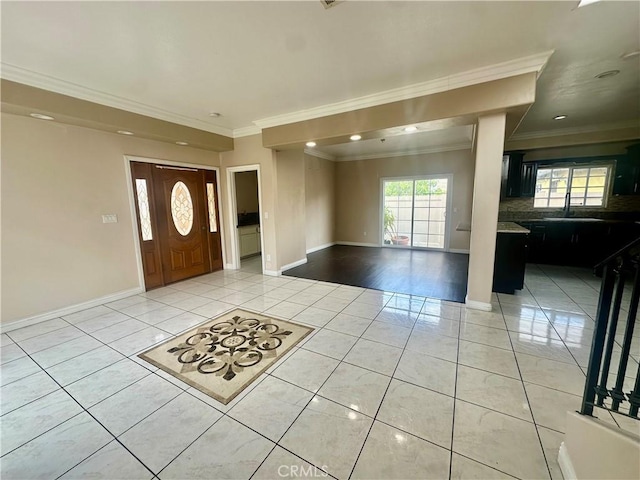 foyer entrance with light tile patterned floors, recessed lighting, ornamental molding, and baseboards