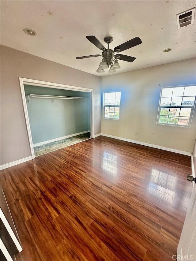 12219 S Main St, Los Angeles, CA 90061 - unfurnished bedroom with wood finished floors, a closet, and a ceiling fan