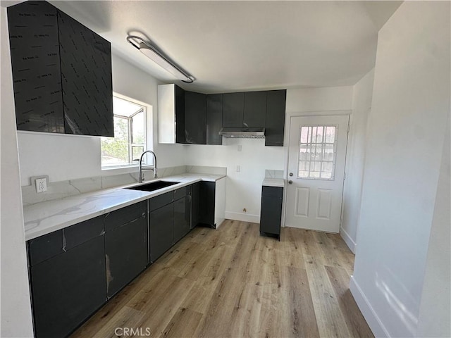 12219 S Main St, Los Angeles, CA 90061 - kitchen featuring light wood-style flooring and light stone counters