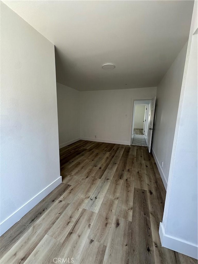 12219 S Main St, Los Angeles, CA 90061 - unfurnished room featuring wood finished floors and baseboards