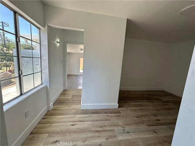 12219 S Main St, Los Angeles, CA 90061 - empty room with healthy amount of natural light and light wood-style flooring