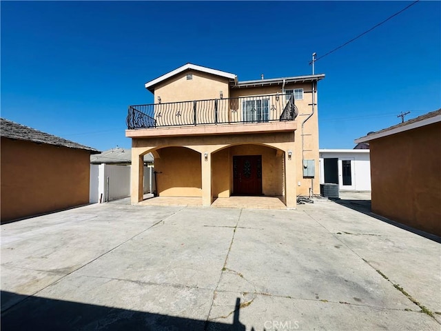 12219 S Main St, Los Angeles, CA 90061 - traditional-style home with a balcony and stucco siding