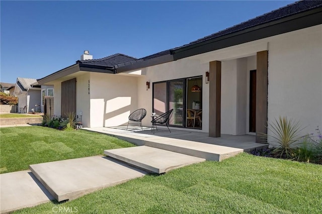 5306 Maricopa St, Torrance, CA 90503 - back of property featuring stucco siding, a chimney, a lawn, and a patio area