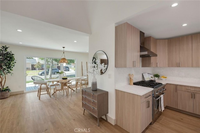 5306 Maricopa St, Torrance, CA 90503 - kitchen featuring high end stove, wall chimney exhaust hood, light wood-style floors, recessed lighting, and tasteful backsplash