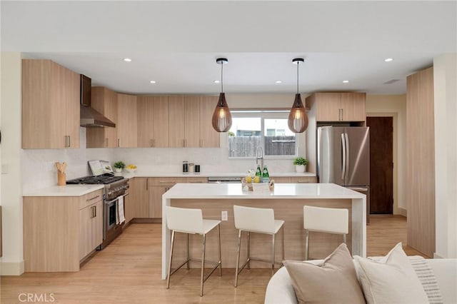 5306 Maricopa St, Torrance, CA 90503 - kitchen with appliances with stainless steel finishes, wall chimney exhaust hood, light countertops, light brown cabinetry, and backsplash