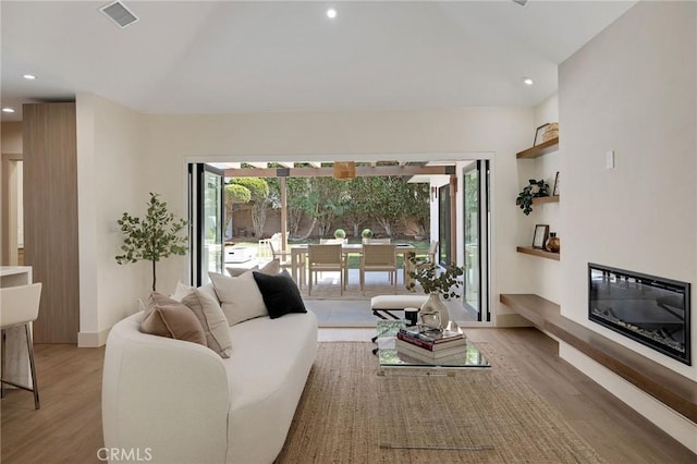 5306 Maricopa St, Torrance, CA 90503 - living area featuring light wood-type flooring, a glass covered fireplace, and recessed lighting