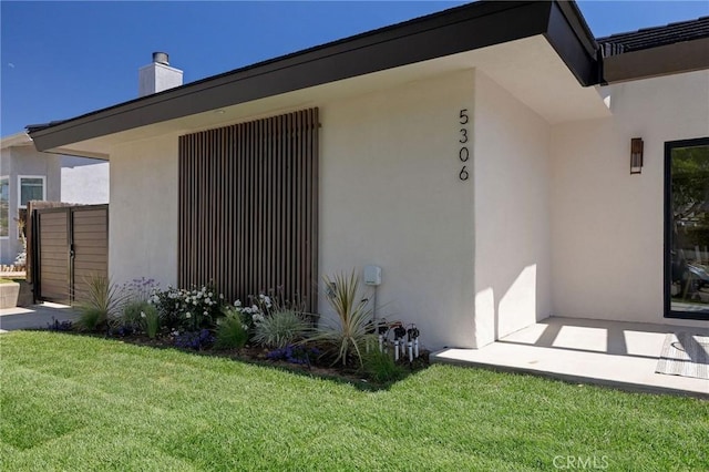 5306 Maricopa St, Torrance, CA 90503 - view of home's exterior with stucco siding, a lawn, and a chimney