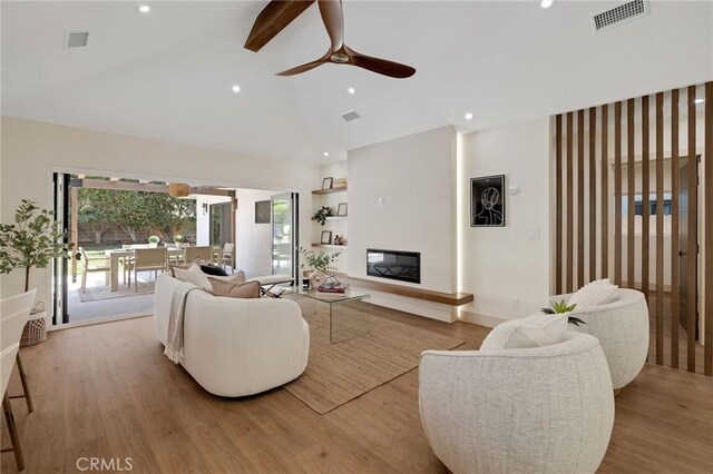 5306 Maricopa St, Torrance, CA 90503 - living area with a ceiling fan, high vaulted ceiling, wood finished floors, a glass covered fireplace, and beam ceiling