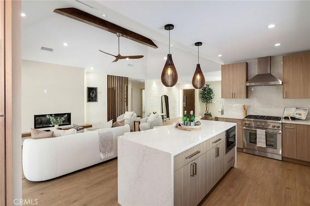 5306 Maricopa St, Torrance, CA 90503 - kitchen featuring wall chimney exhaust hood, high end stainless steel range, built in microwave, light wood-type flooring, and a kitchen island