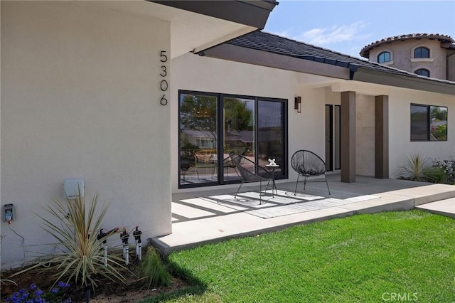 5306 Maricopa St, Torrance, CA 90503 - back of house featuring stucco siding, a lawn, and a patio area