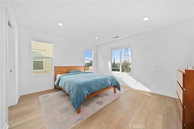 bedroom featuring recessed lighting, baseboards, visible vents, and light wood-style floors