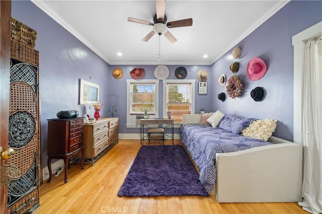 bedroom featuring a ceiling fan, crown molding, baseboards, and light wood-type flooring