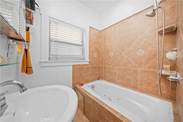bathroom featuring a tile shower, a sink, and a jetted tub