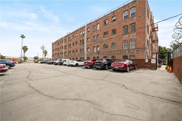 view of building exterior featuring uncovered parking