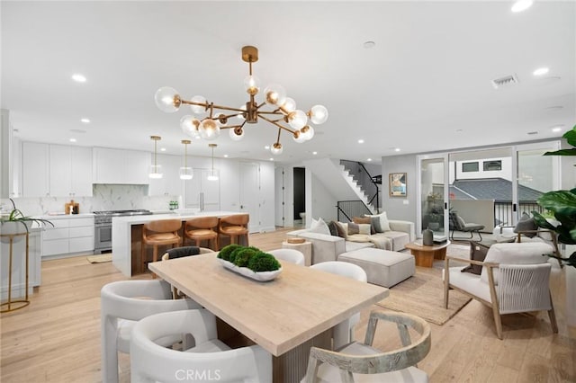 dining space featuring stairway, light wood-type flooring, visible vents, and recessed lighting