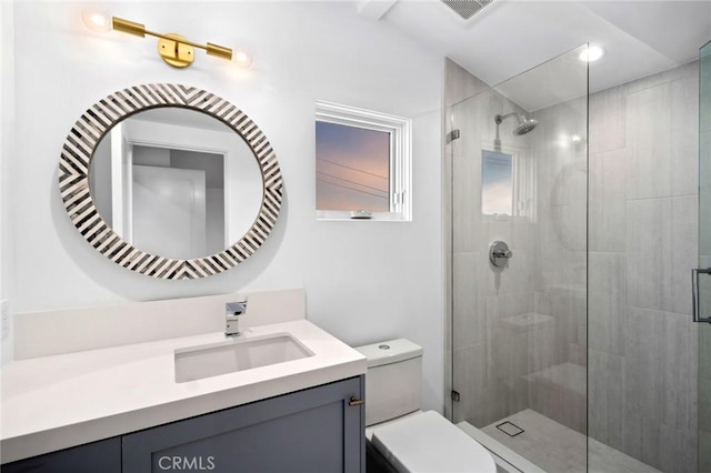 full bathroom with vanity, toilet, a shower stall, and visible vents