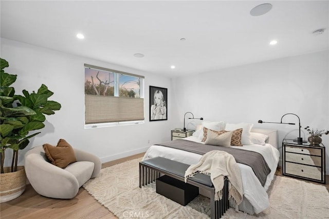 bedroom featuring wood finished floors, baseboards, and recessed lighting