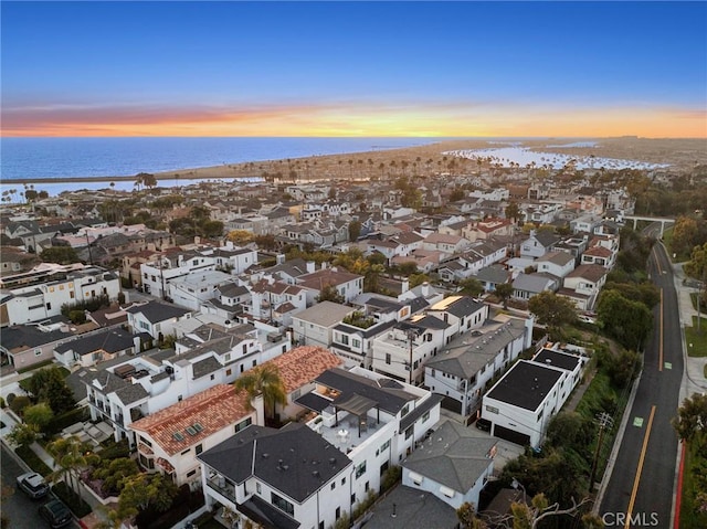 drone / aerial view featuring a water view and a residential view