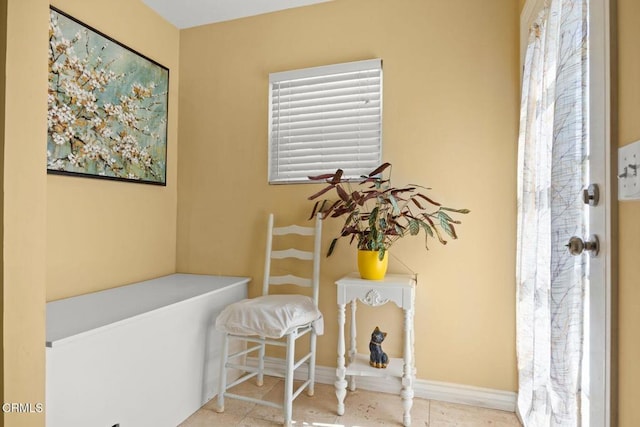 sitting room featuring tile patterned floors and baseboards