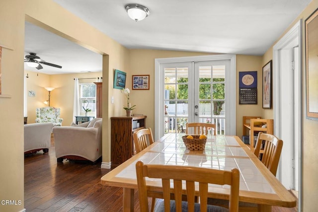 dining space featuring french doors, a ceiling fan, and dark wood-type flooring