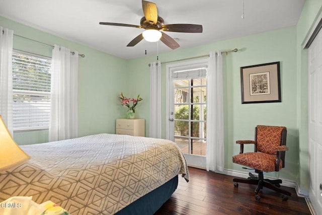 bedroom with a closet, ceiling fan, wood finished floors, and multiple windows