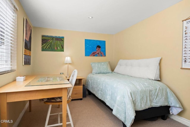 bedroom with baseboards and carpet