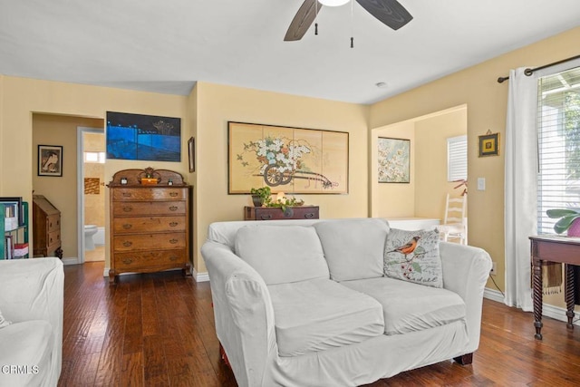 living room with baseboards, ceiling fan, and hardwood / wood-style flooring