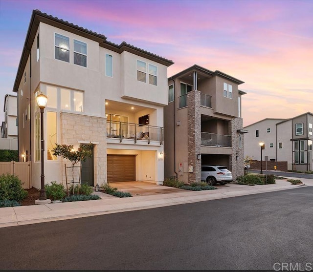 15751 Wainwright Way, San Diego, CA 92127 - view of front of property featuring a garage, stucco siding, stone siding, and driveway