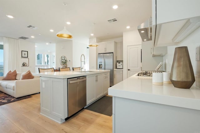 15751 Wainwright Way, San Diego, CA 92127 - kitchen with appliances with stainless steel finishes, light wood-type flooring, extractor fan, open floor plan, and recessed lighting