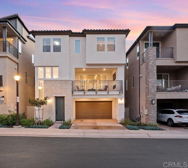 15751 Wainwright Way, San Diego, CA 92127 - view of front of house featuring stucco siding, stone siding, driveway, a garage, and a balcony