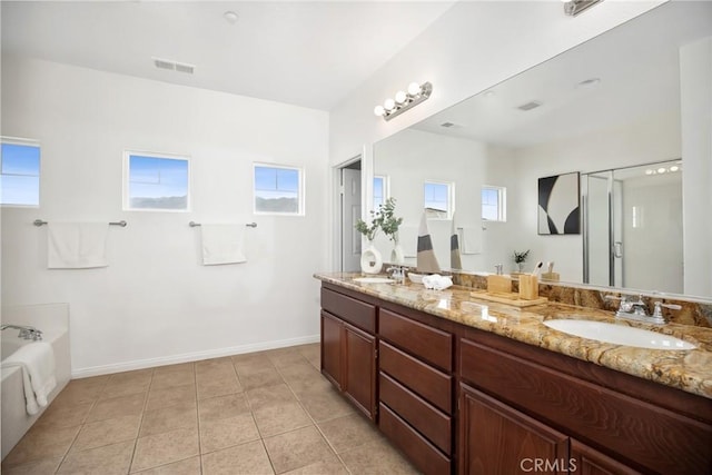 full bath featuring visible vents, baseboards, tile patterned floors, a sink, and a garden tub