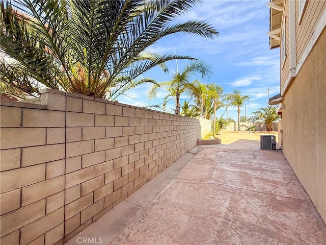 exterior space with a fenced backyard and central AC unit
