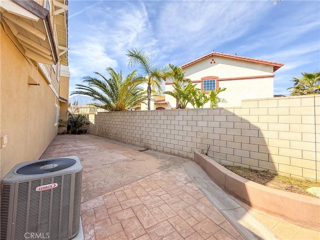 view of patio / terrace featuring cooling unit and a fenced backyard