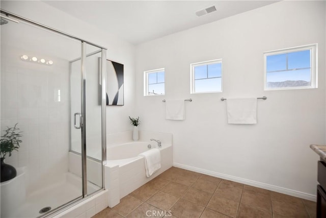 bathroom featuring vanity, a garden tub, a shower stall, tile patterned flooring, and baseboards