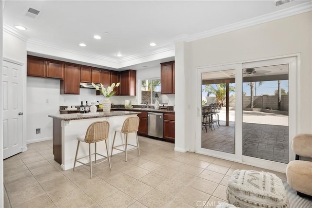 kitchen with dishwasher, ornamental molding, a kitchen bar, a ceiling fan, and a kitchen island