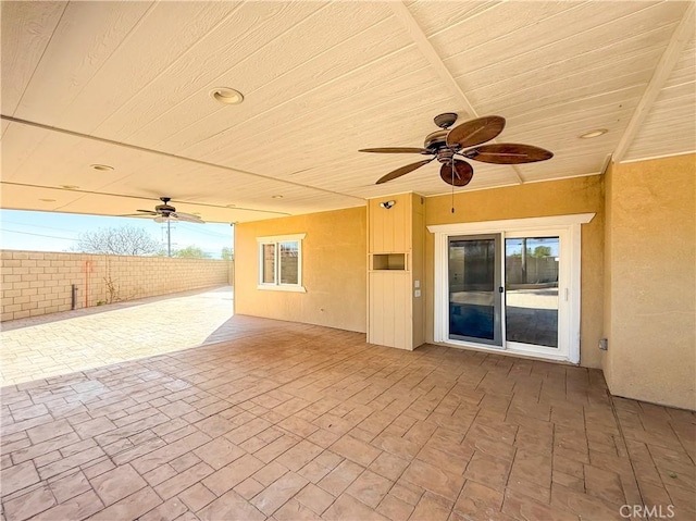 view of patio featuring fence and a ceiling fan