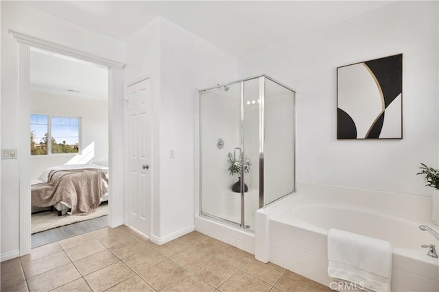 ensuite bathroom featuring a shower stall, tile patterned floors, connected bathroom, and a garden tub